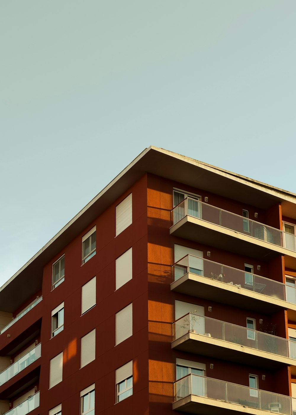 a tall red building with balconies and balconies