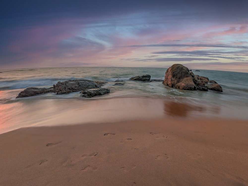 a beach that has some rocks in it