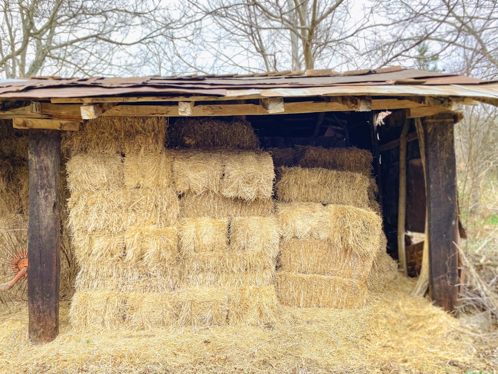 a barn with hay bales stacked on top of it