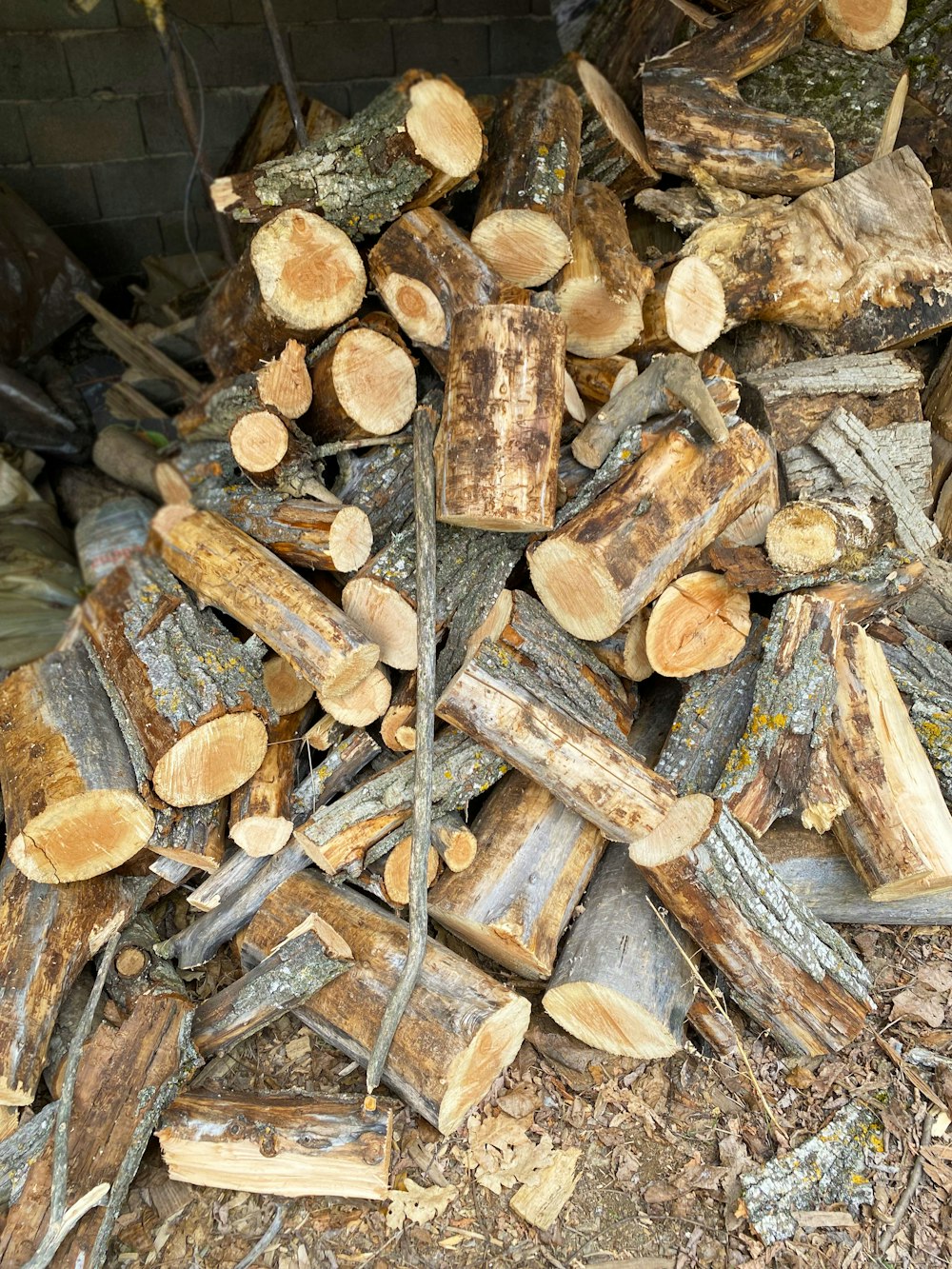 a pile of cut logs sitting on top of a pile of wood