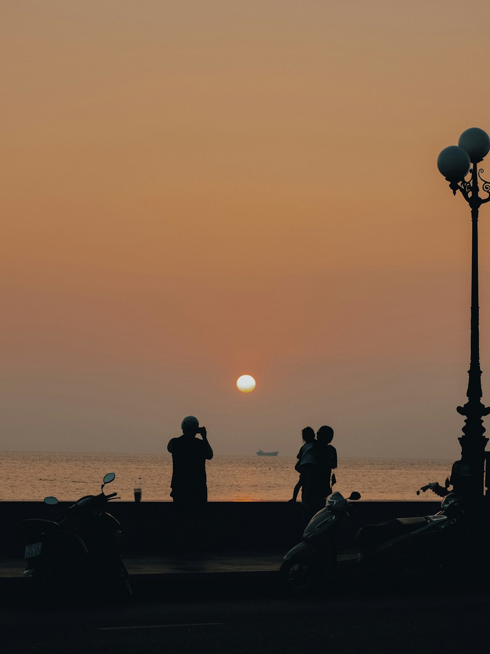 a couple of people standing next to a street light