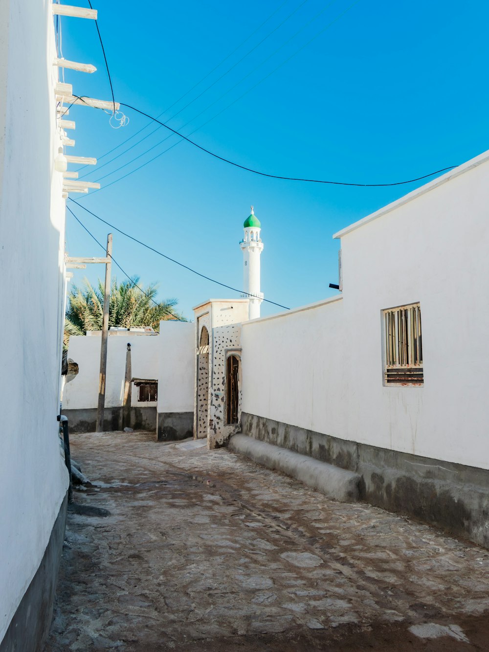 a white building with a white tower in the background