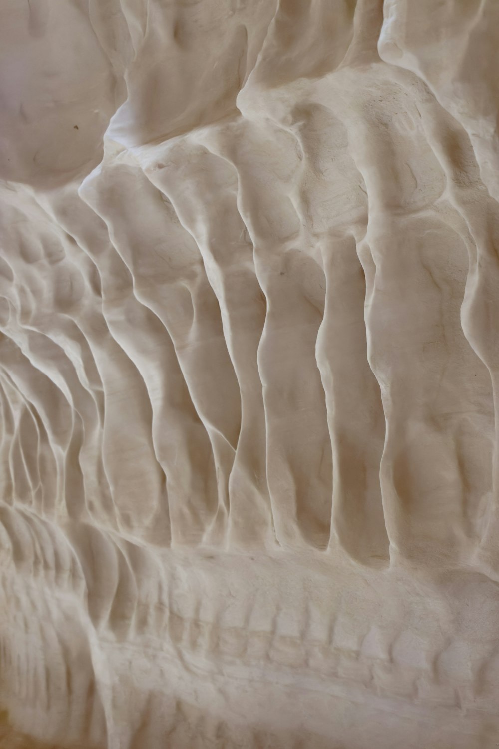 a close up view of a white textured wall