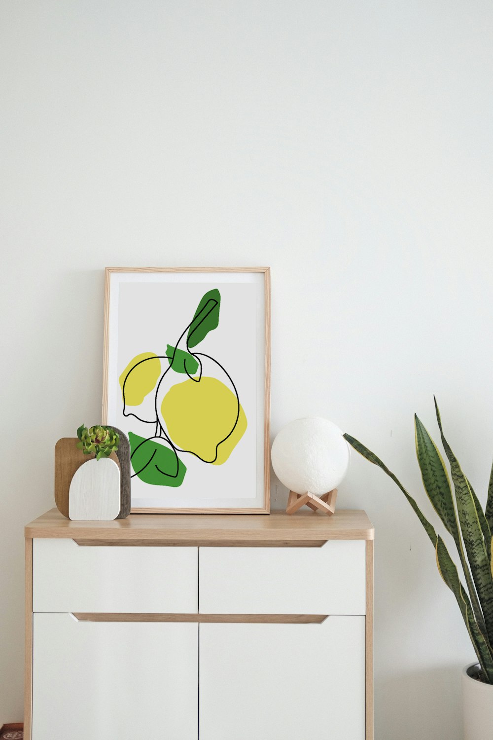 a picture of a lemon on a shelf next to a potted plant