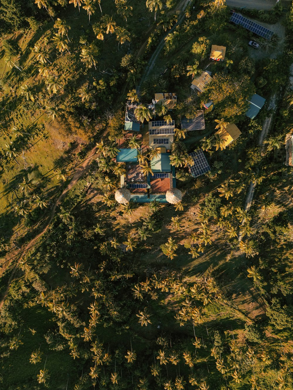 an aerial view of a house in the middle of a forest