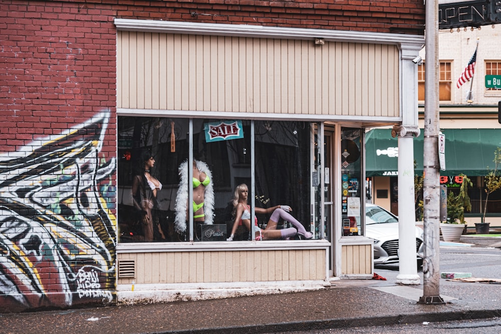 a group of women in lingerie shop window display