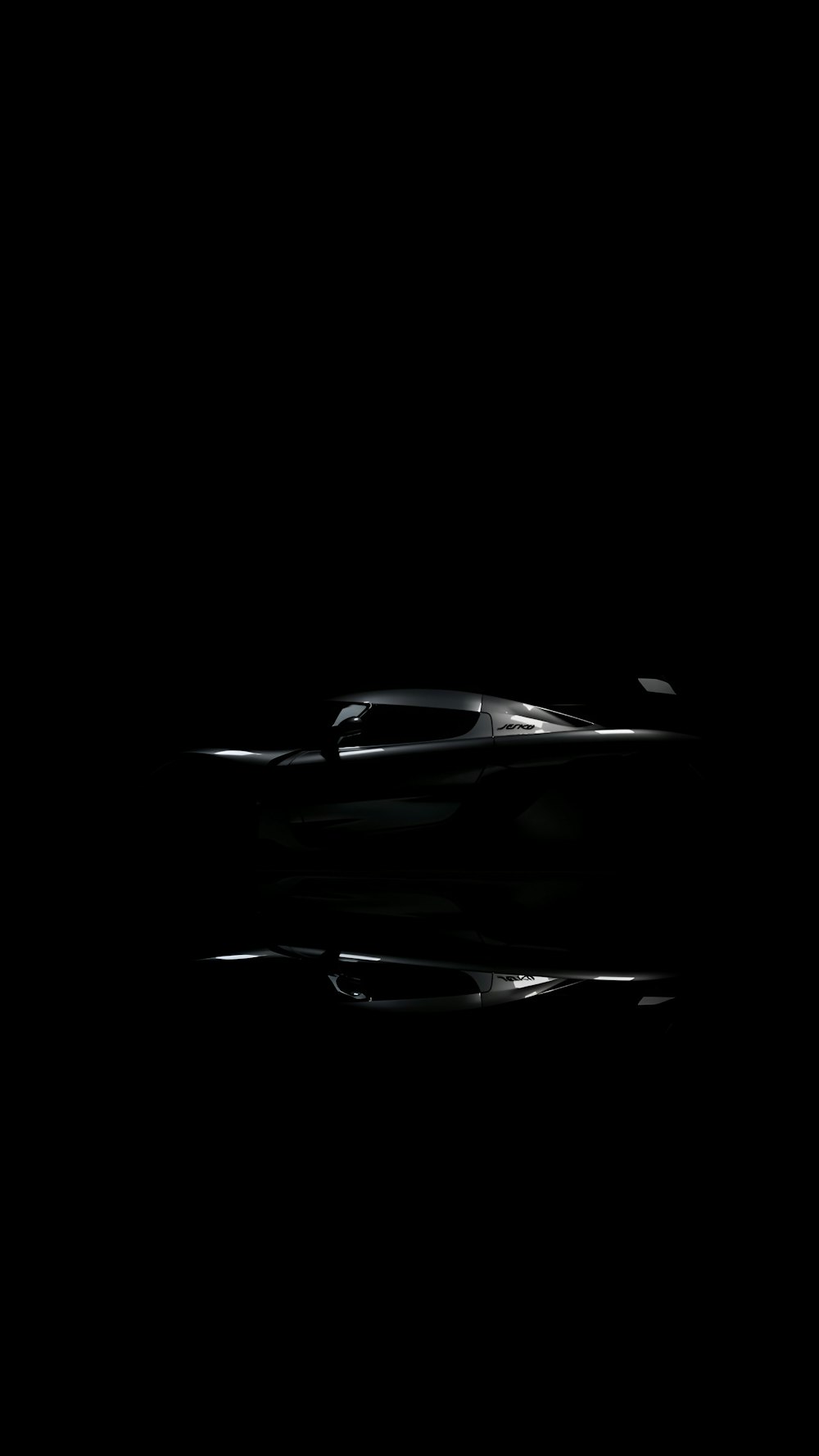 a black and white photo of a car in the dark
