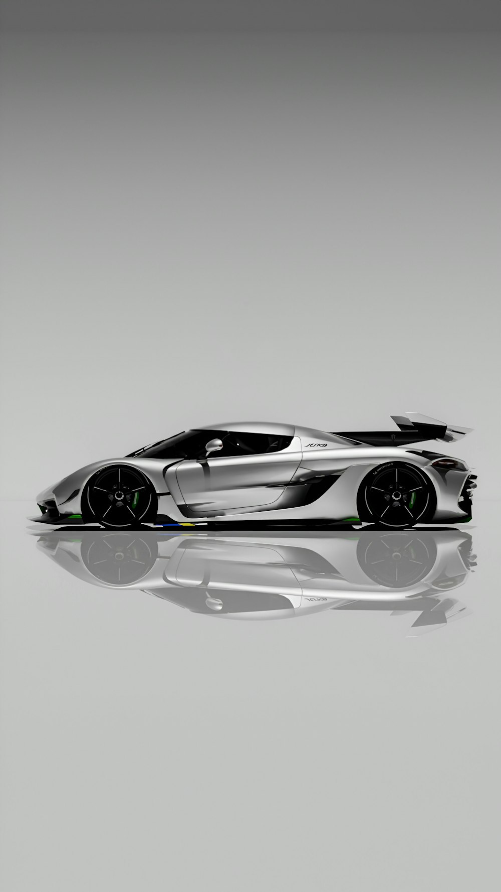 a silver sports car on a reflective surface