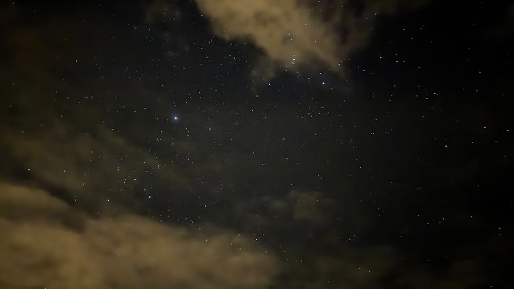 the night sky with stars and clouds