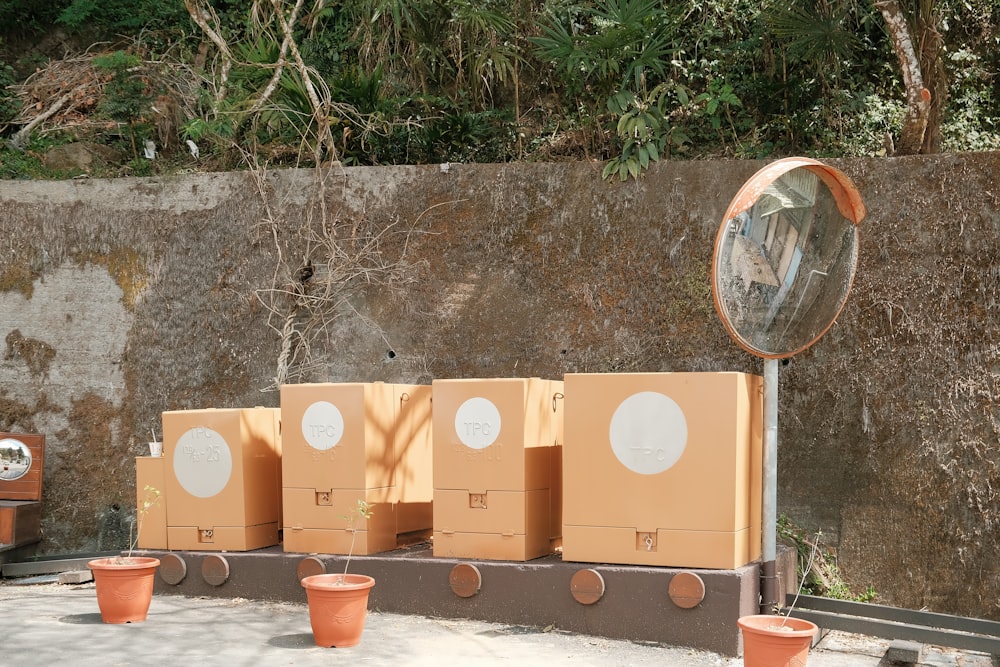 a row of boxes sitting next to a wall