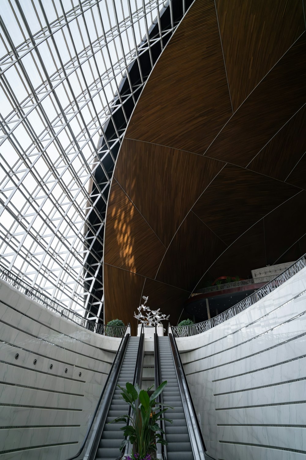 an escalator in a large building with a skylight
