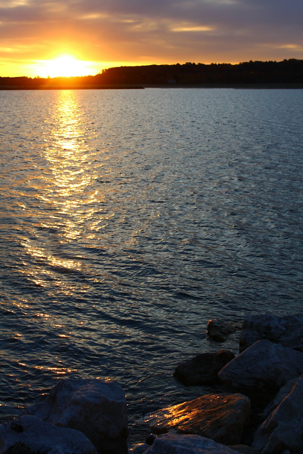 the sun is setting over a body of water