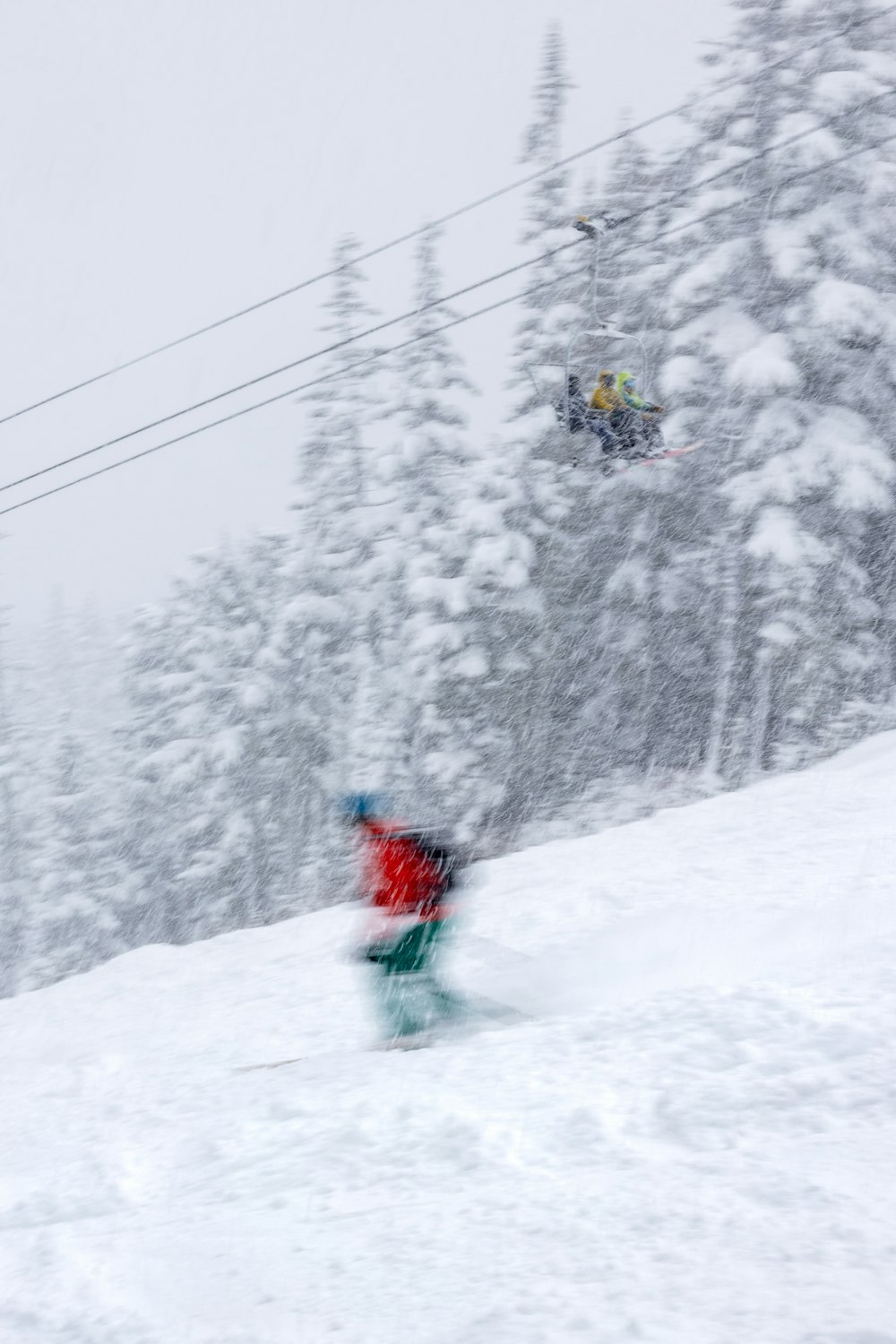 a person riding a snowboard down a snow covered slope