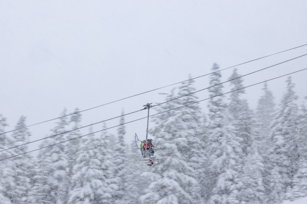 a person riding a ski lift on a snowy day