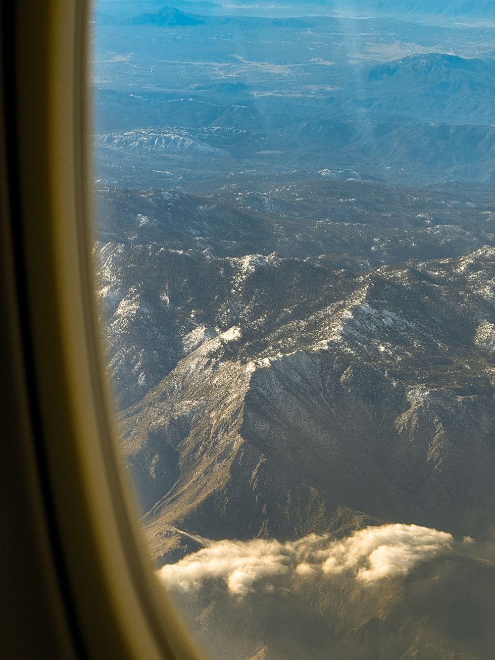 a view of a mountain range from an airplane window