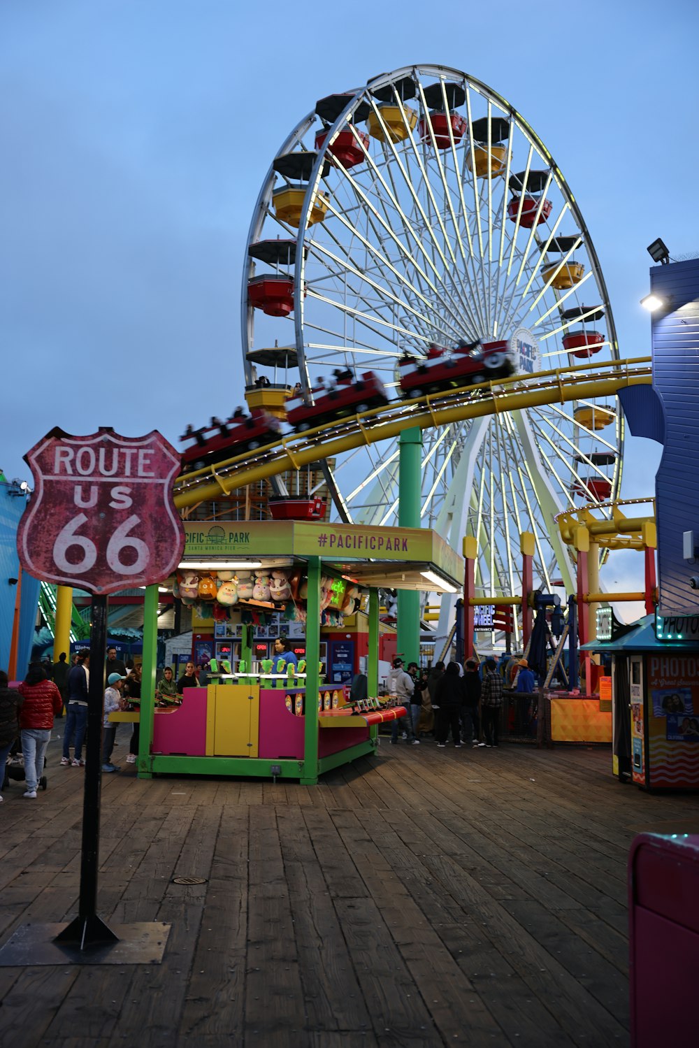 a carnival ride with a ferris wheel in the background