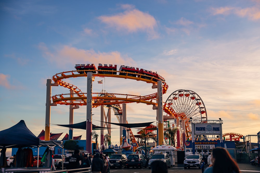 a roller coaster at an amusement park at sunset