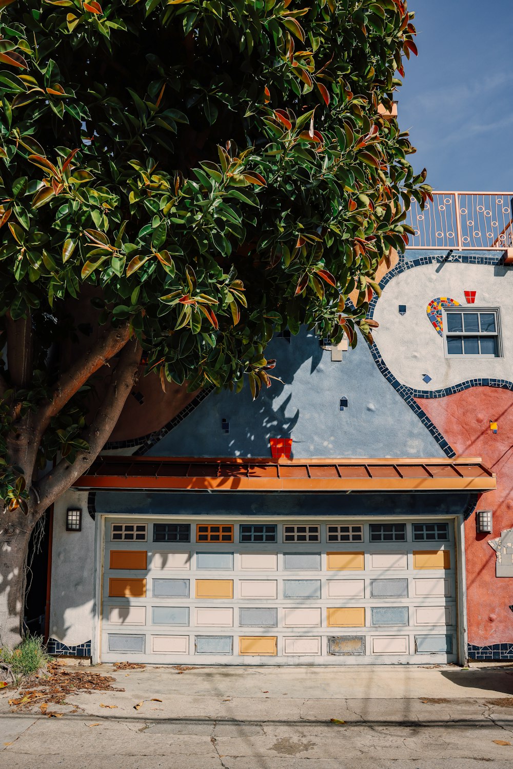 a garage with a tree in front of it