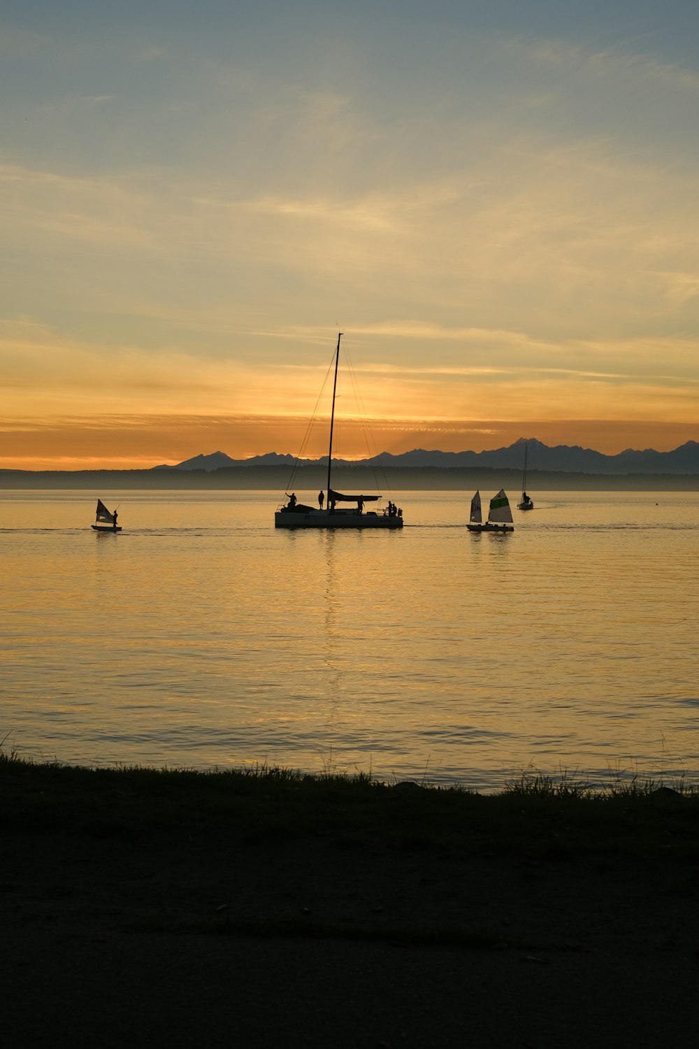 a group of boats floating on top of a large body of water