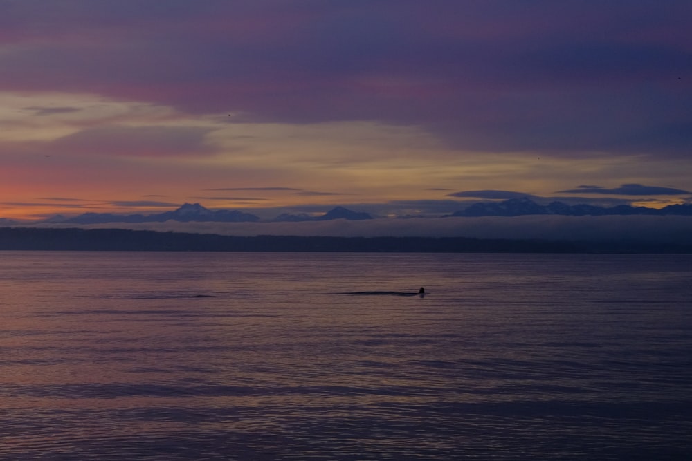 a lone boat in the middle of a large body of water