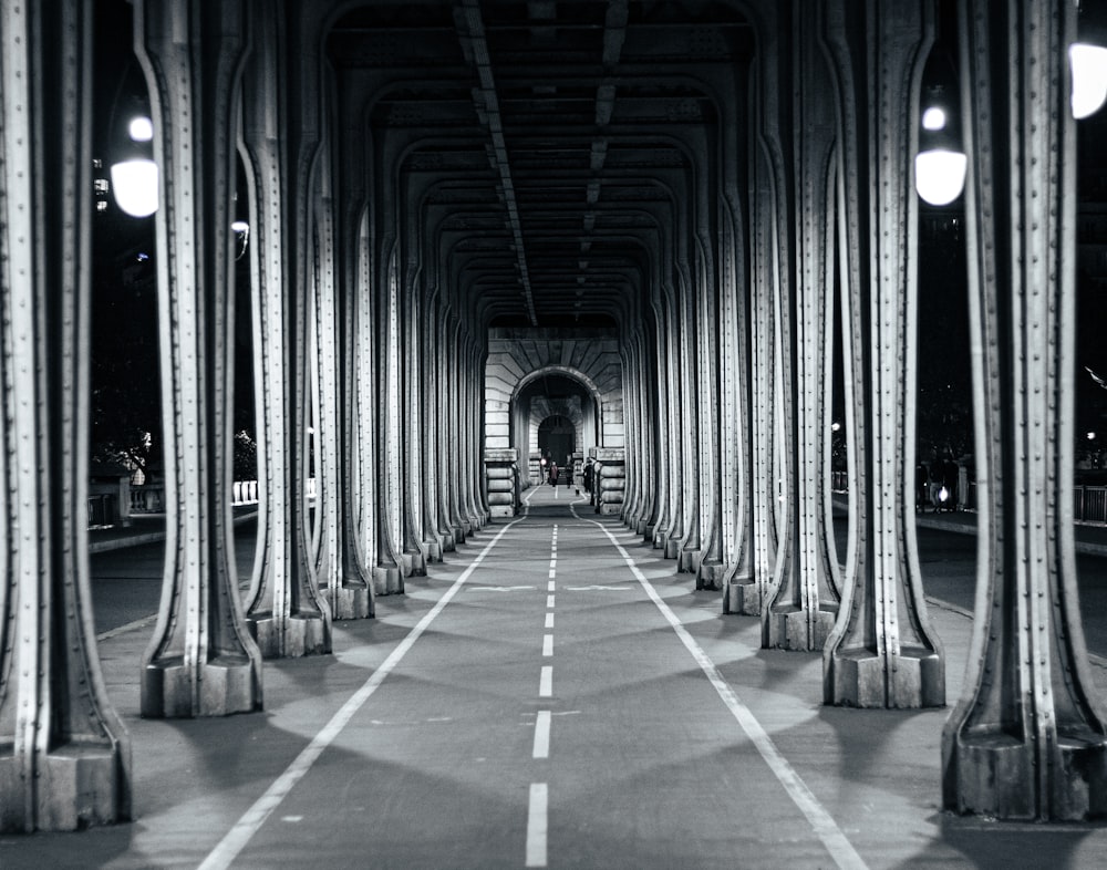 a black and white photo of a long tunnel