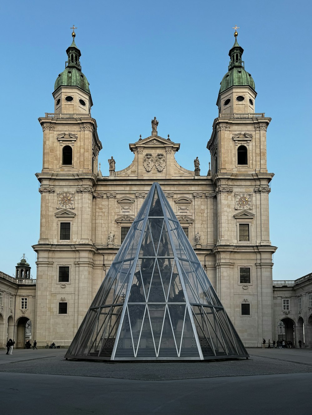 a large building with a glass pyramid in front of it