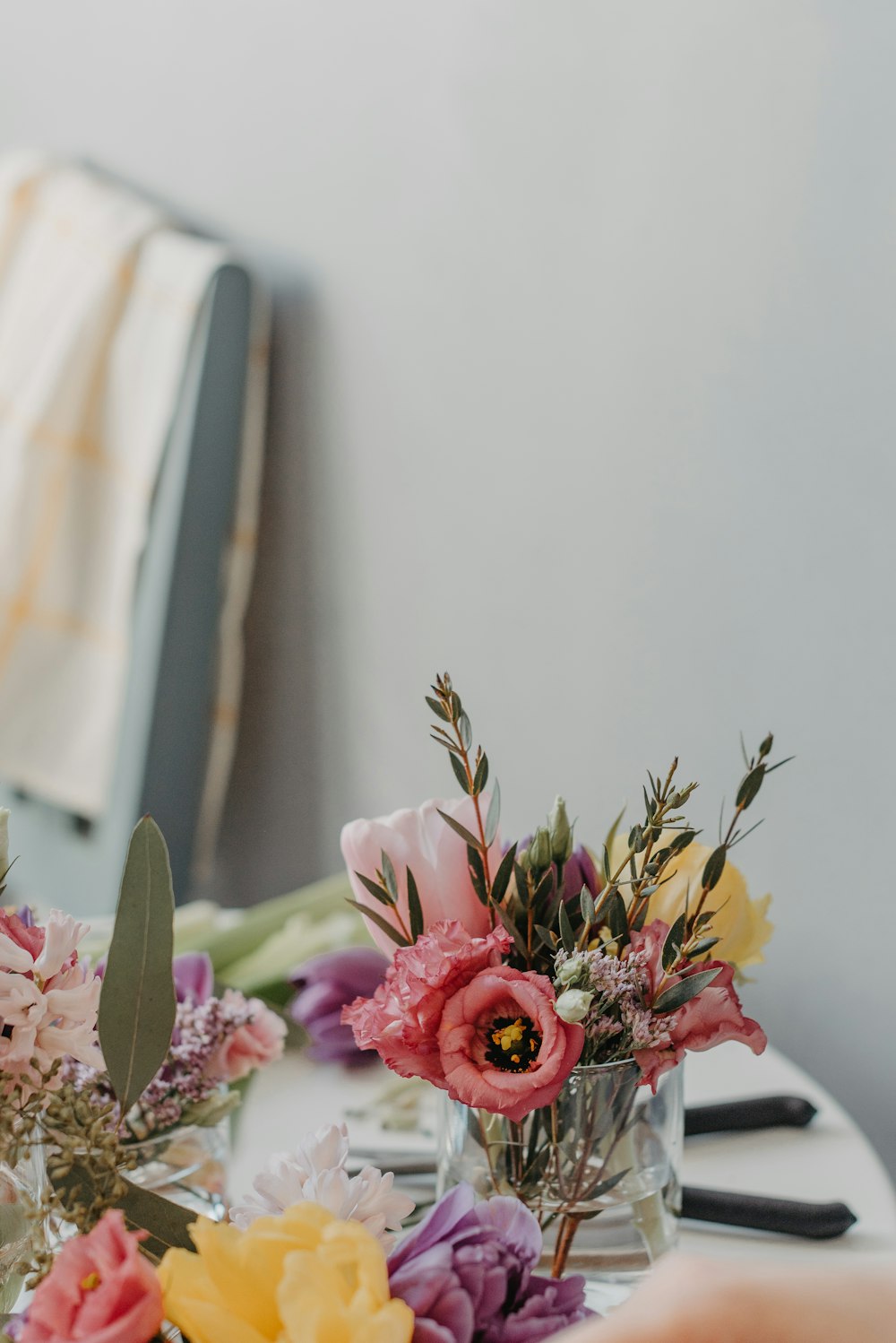 a table topped with vases filled with flowers