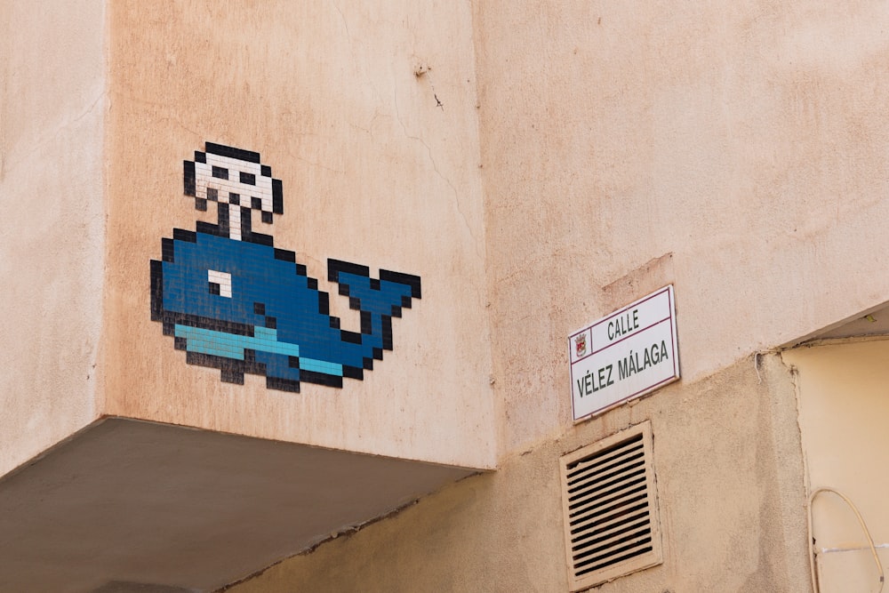 une image d’un rorqual bleu peinte sur le côté d’un bâtiment