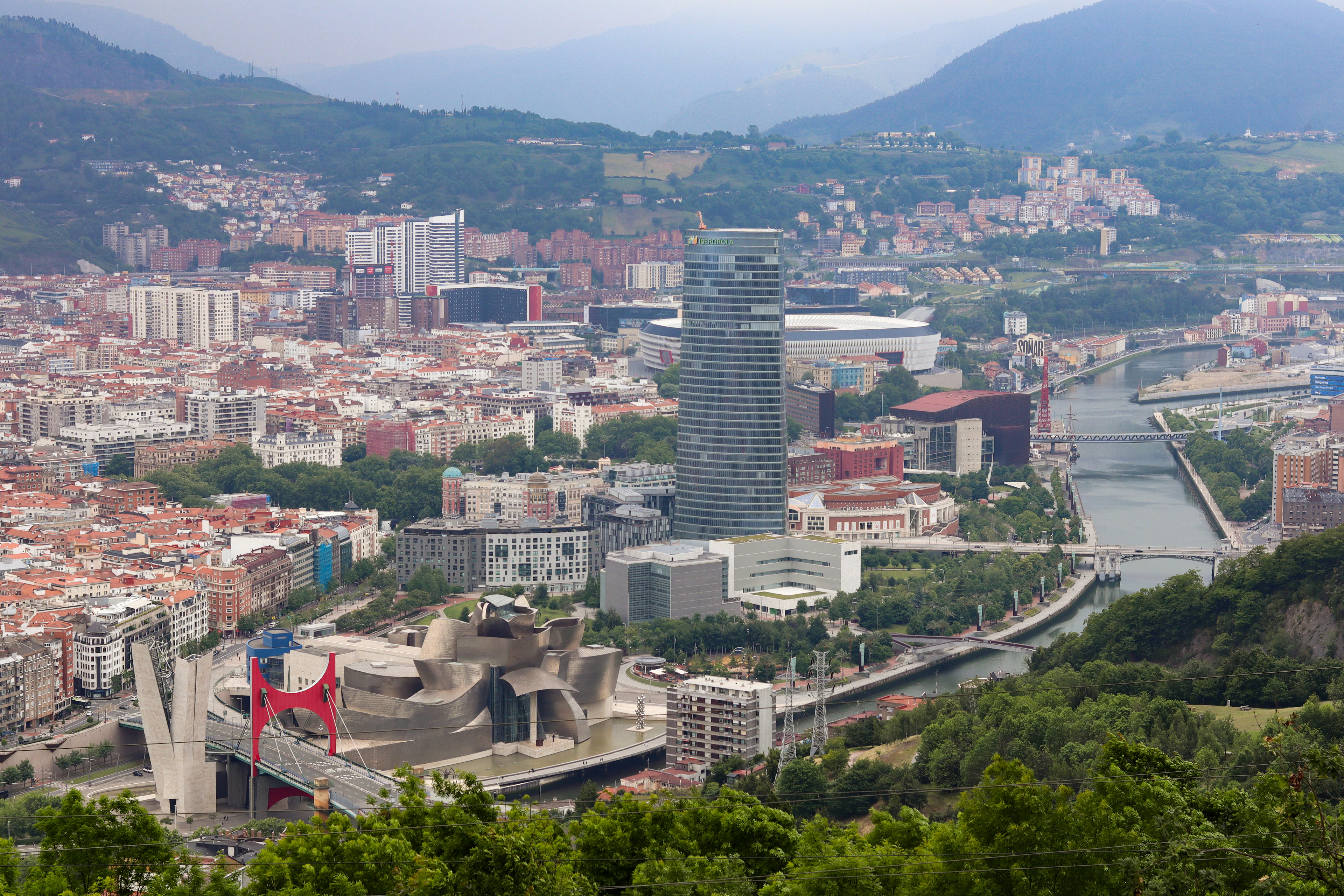 Bilbao from Mount Artxanda: the Guggenheim Museum, the river Nervión and green hills around the city