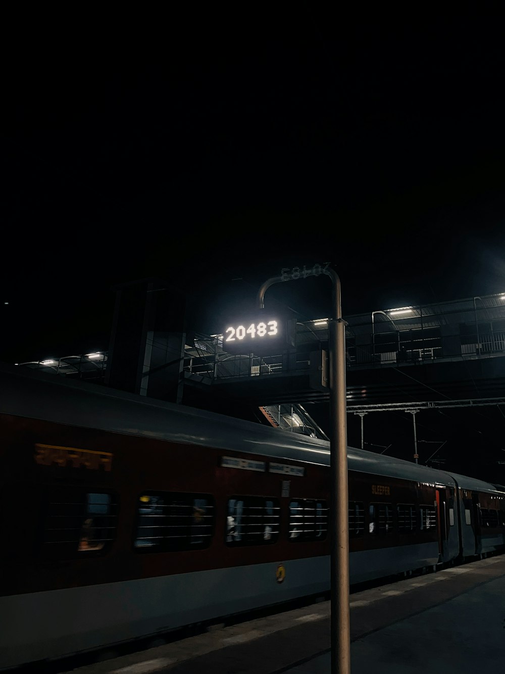 a train traveling past a train station at night