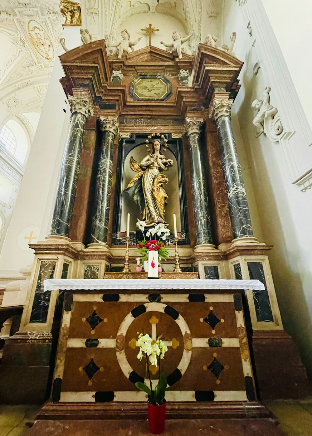 a church with a statue of jesus on the alter