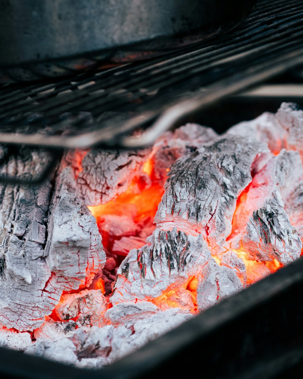 a close up of a grill with hot coals
