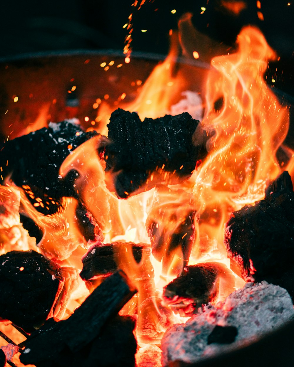 a close up of a bowl of food on fire