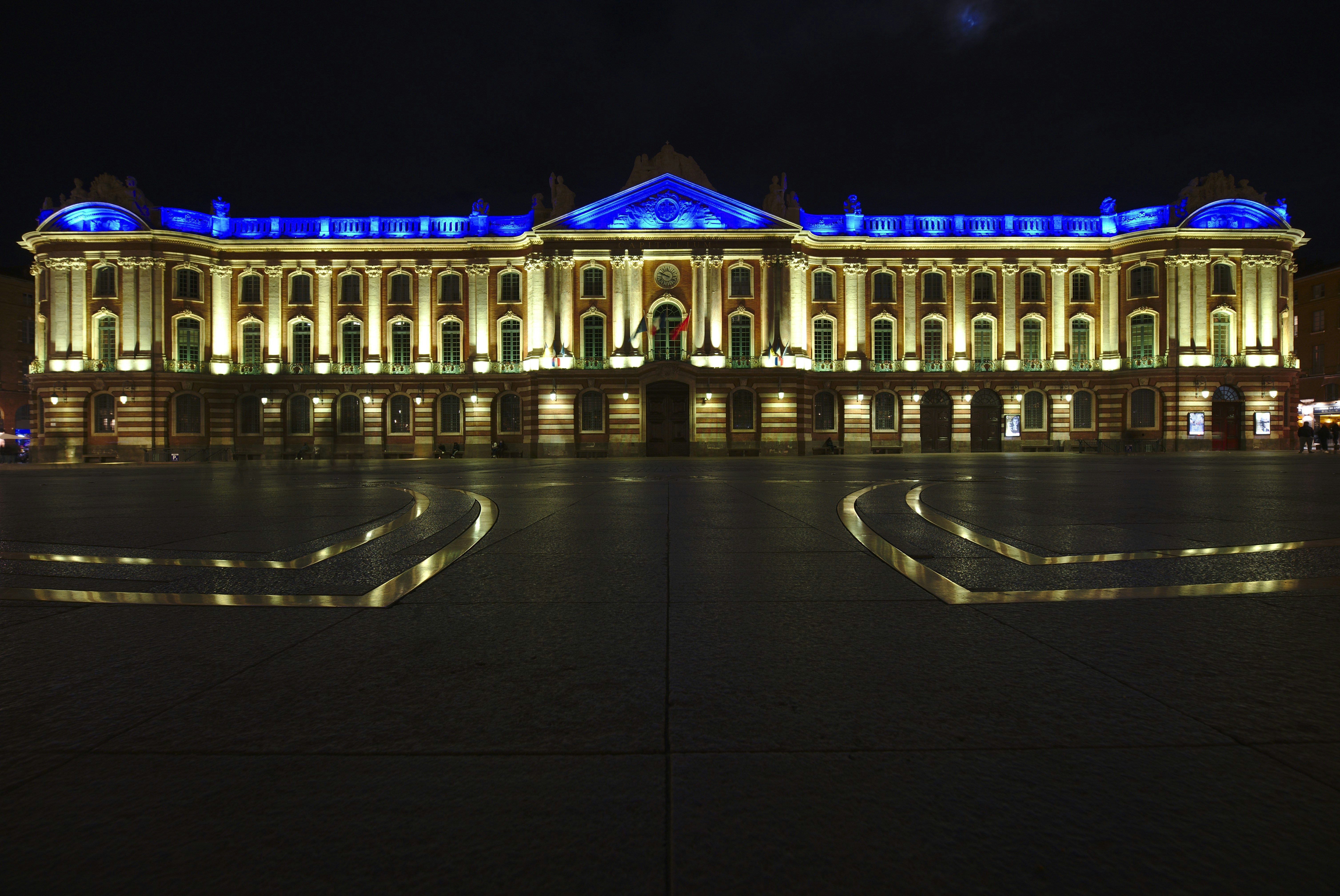 a large building lit up with blue lights