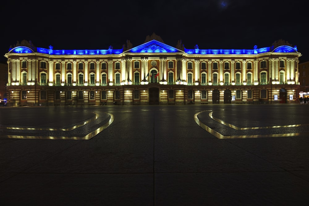 a large building lit up with blue lights