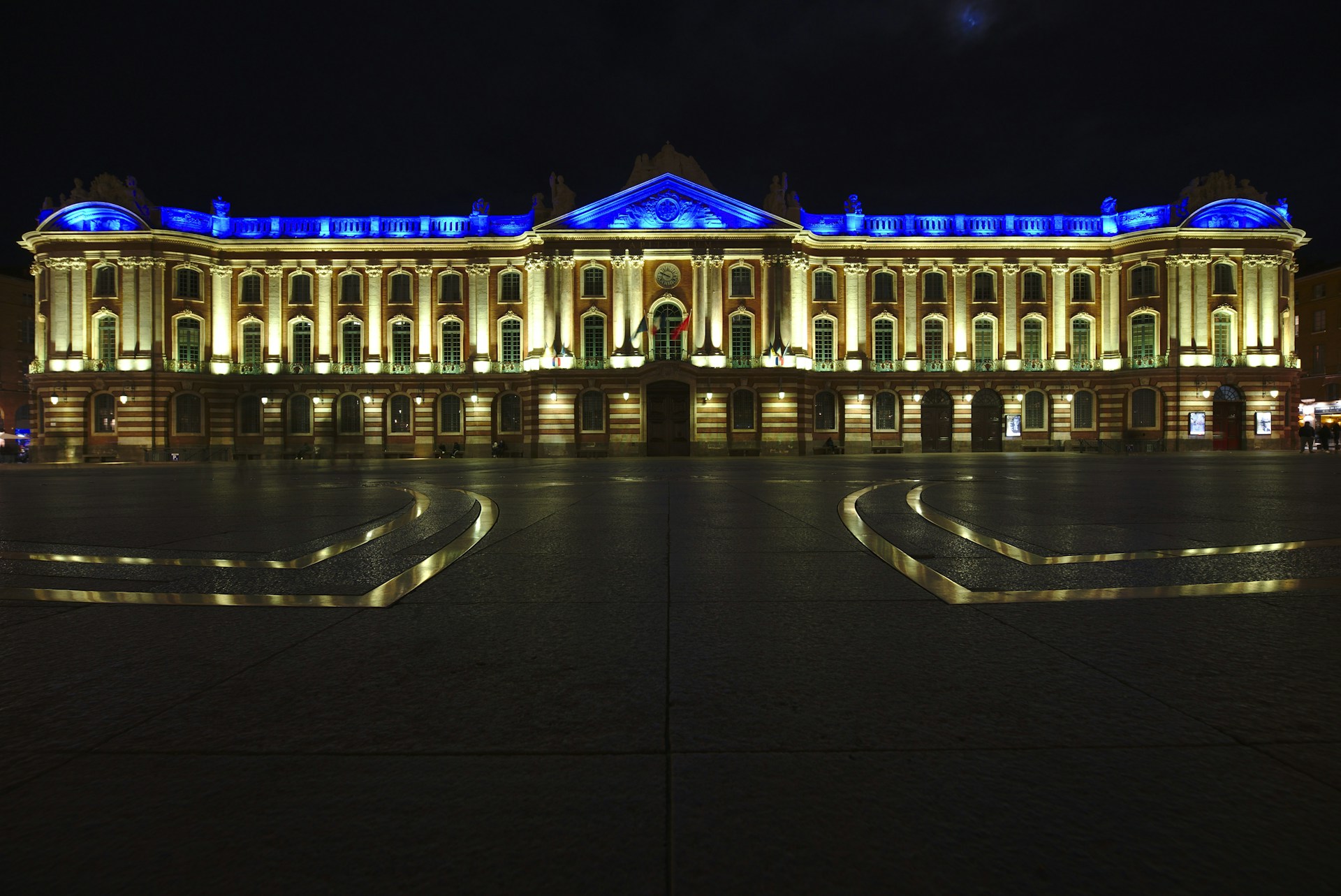 a large building lit up with blue lights