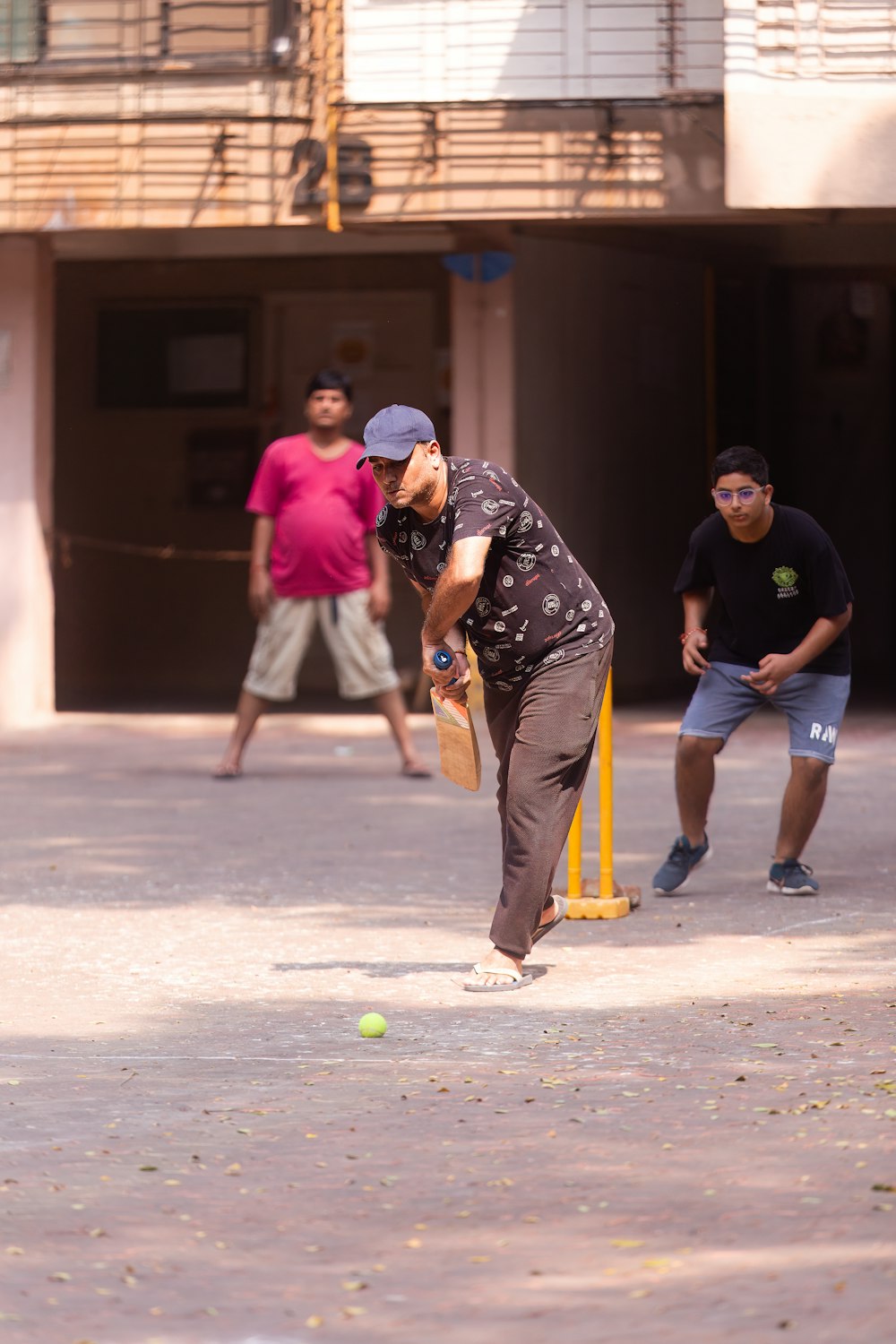 a man hitting a ball with a bat