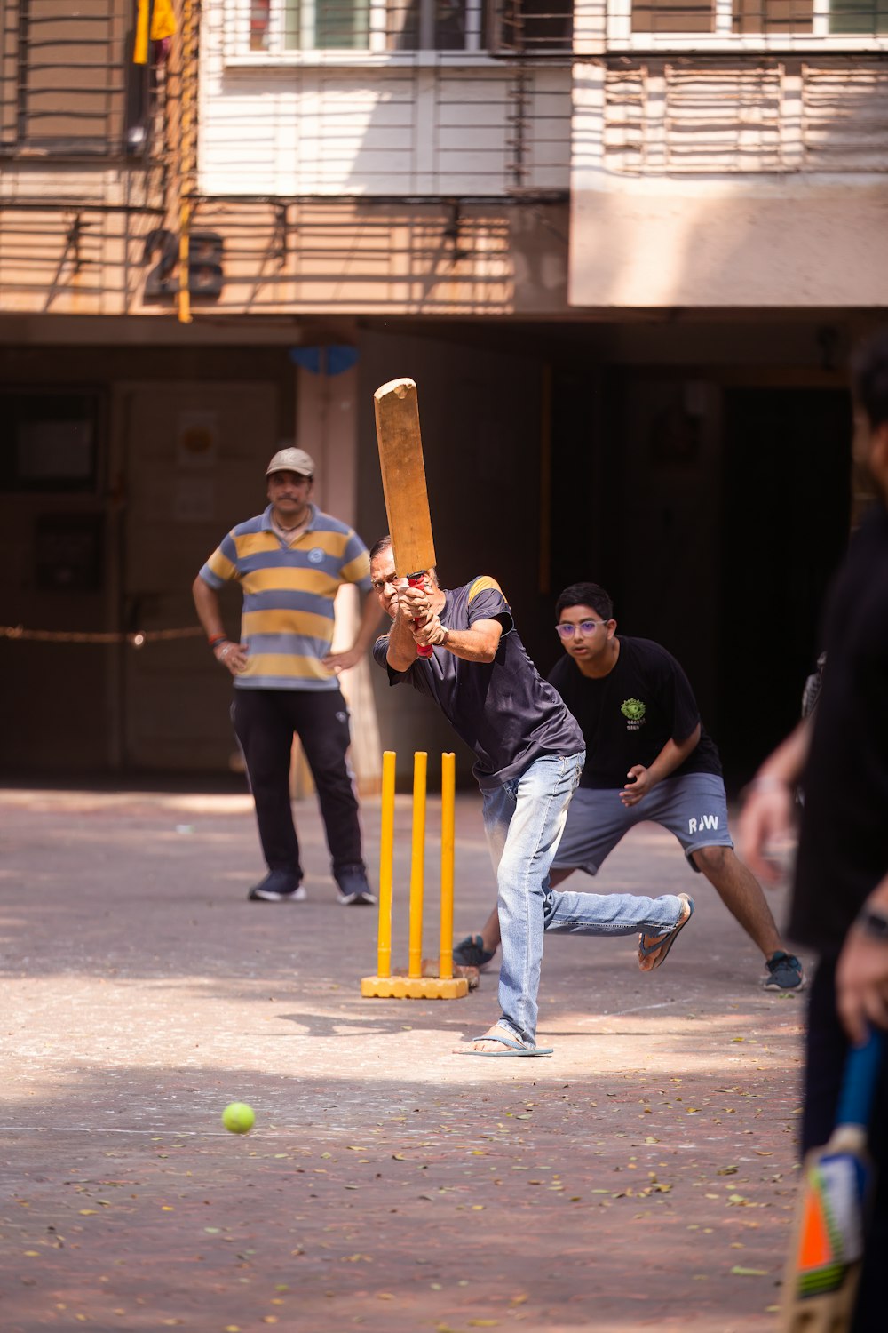 a group of men playing a game of cricket