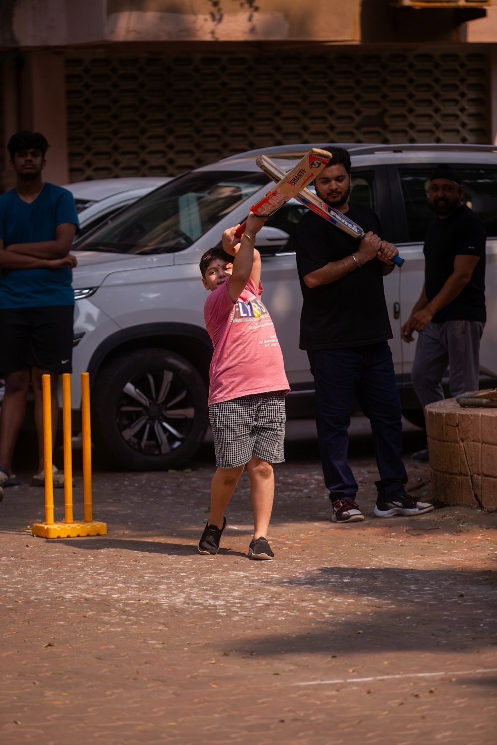 a small child swinging a bat at a ball