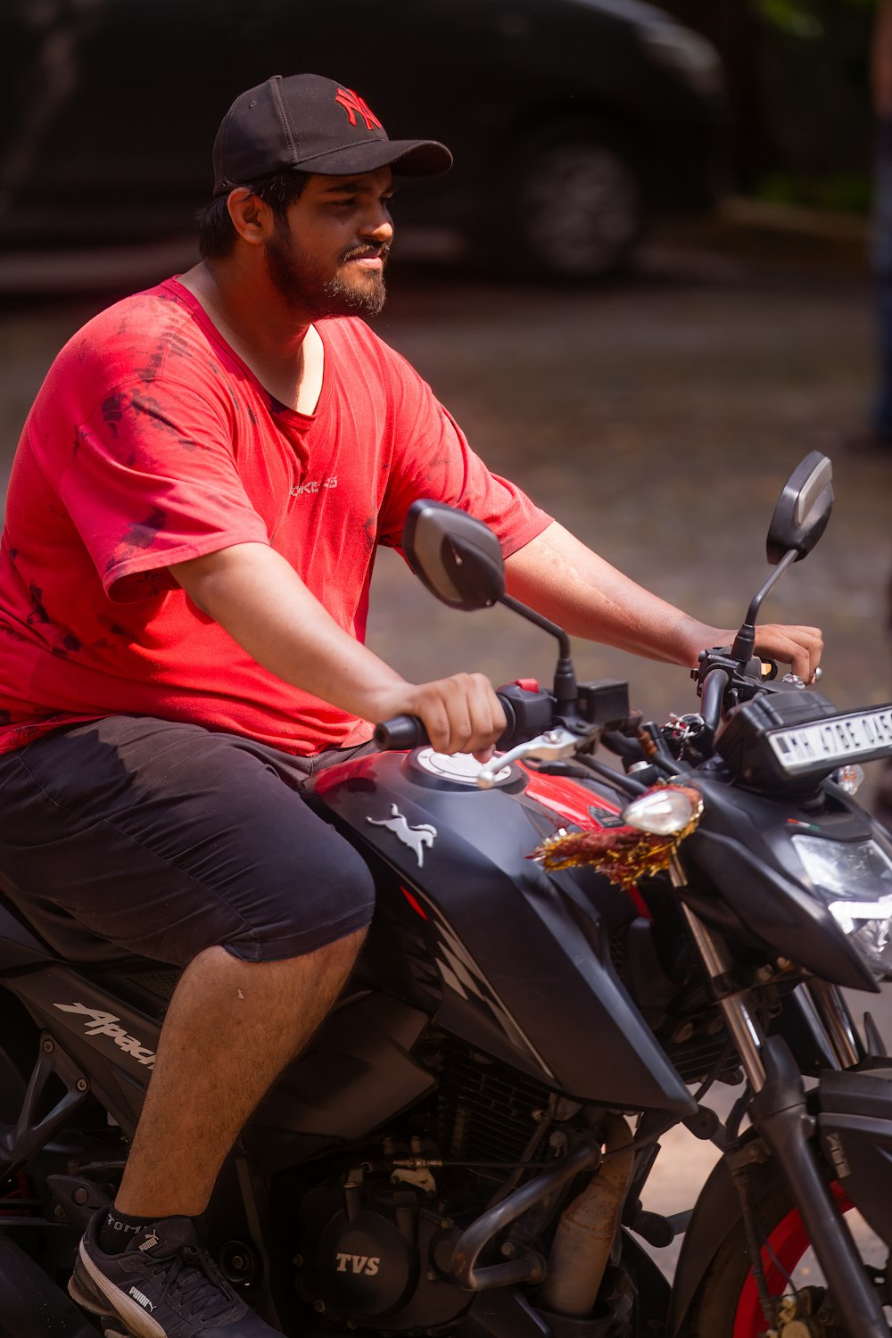 a man riding a motorcycle down a street