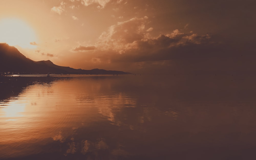 a large body of water under a cloudy sky