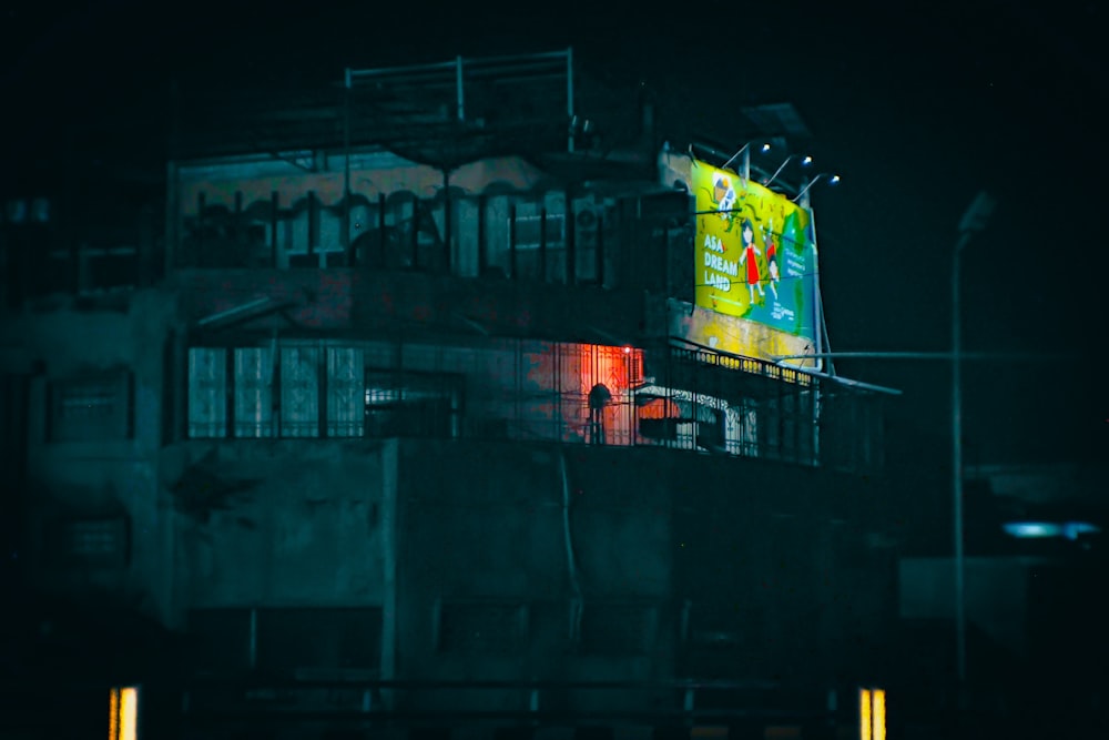 a tall building with a neon sign on it's side