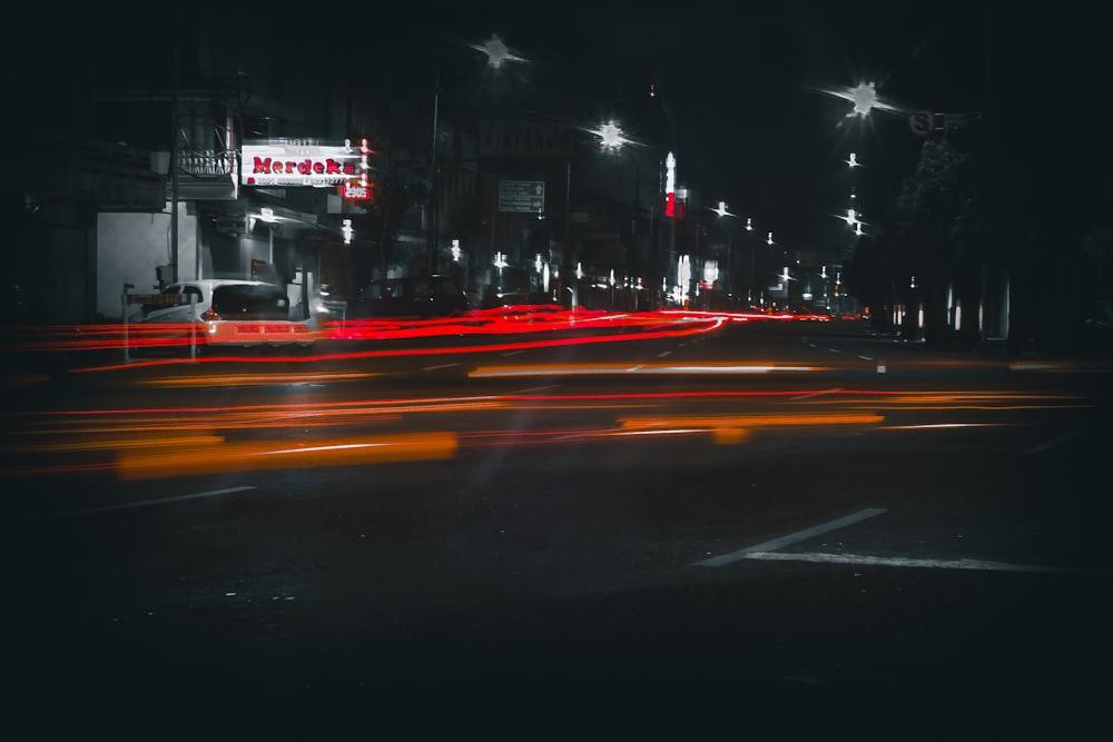 a city street filled with lots of traffic at night