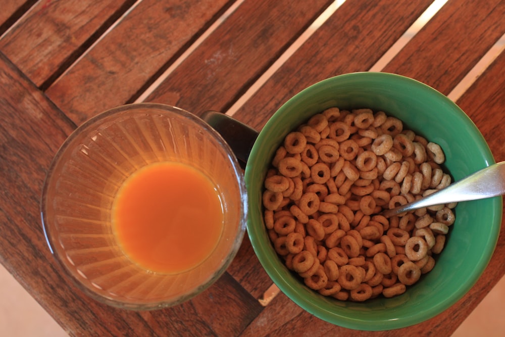 a bowl of cereal and a glass of orange juice