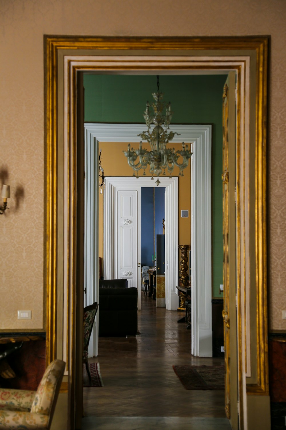 a hallway with a chandelier and a chandelier hanging from the ceiling