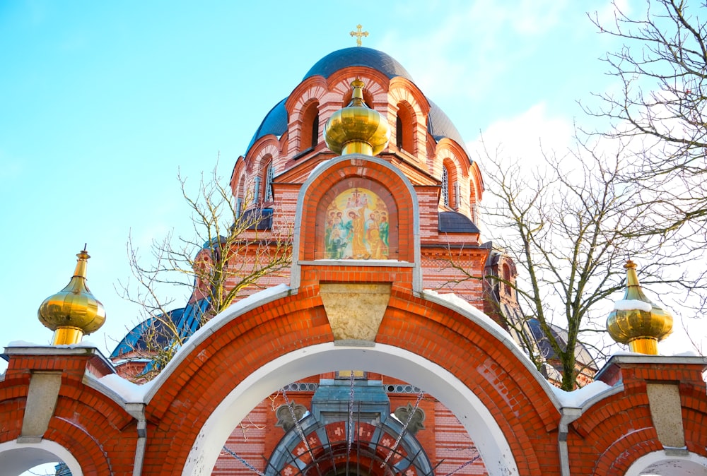 a red and white building with a clock on it's side