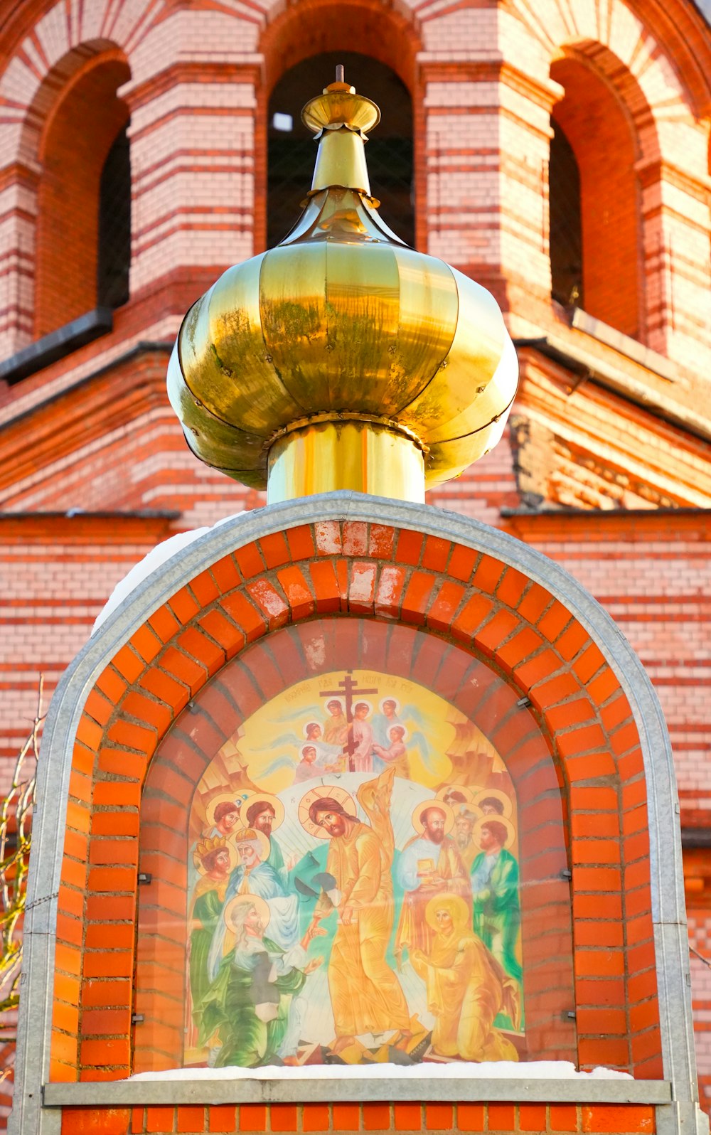 a clock tower with a painting on the front of it