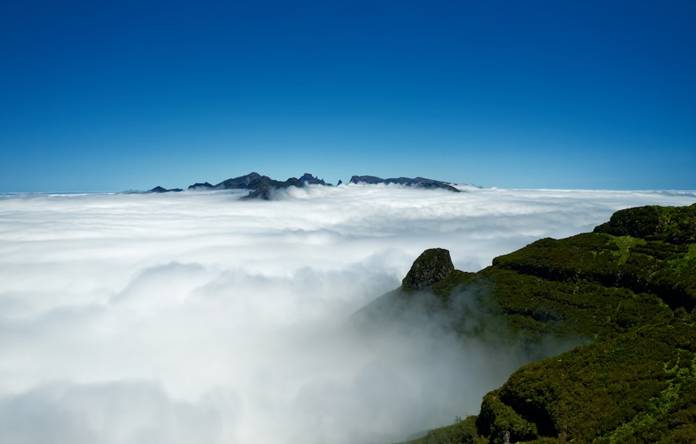 a view of a mountain covered in low lying clouds