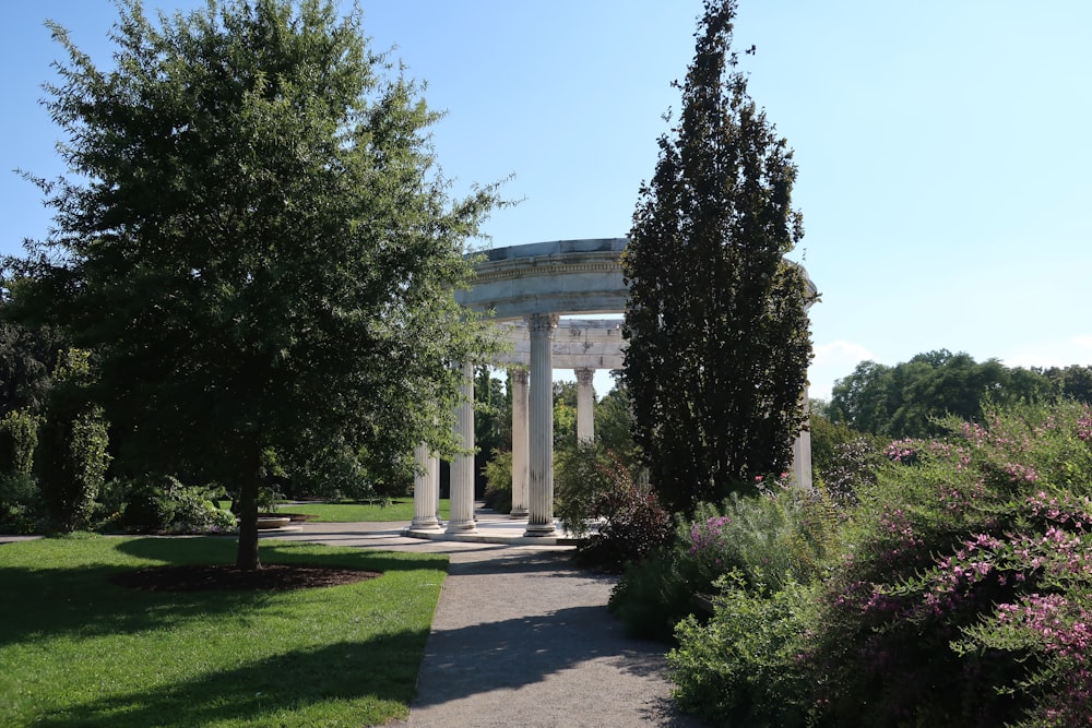 a walkway in a park surrounded by trees and bushes