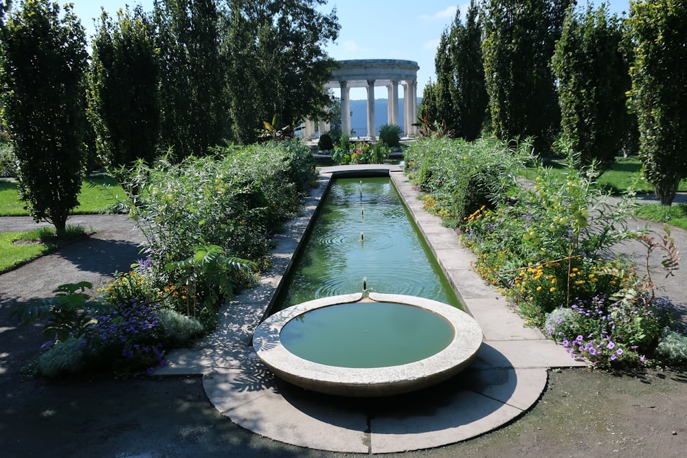 a fountain in the middle of a garden